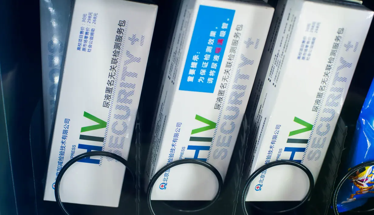 Alat tes HIV yang dijual bersamaan dengan makanan ringan di dalam mesin jual otomatis di sebuah universitas di Chengdu, China, 27 November 2016. Hal ini untuk menekan angka pemuda di China yang semakin meningkat terjangkit virus HIV. (REUTERS/Stringer)