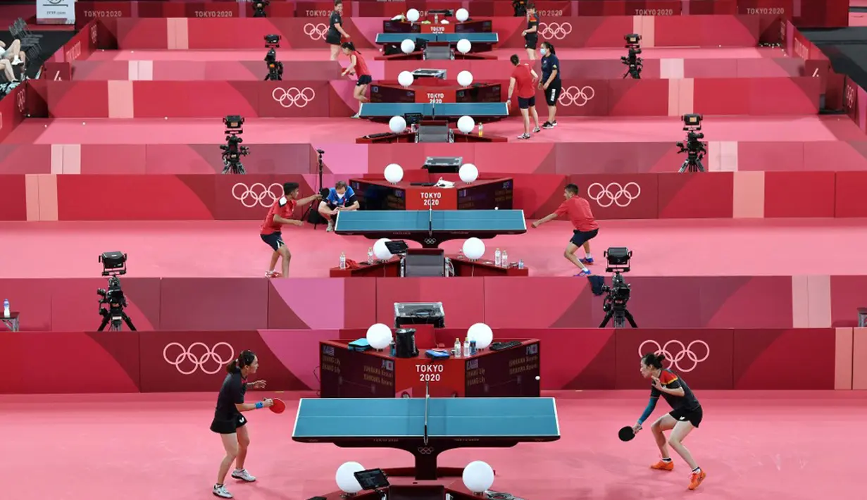 Para pemain tenis meja melakukan sesi latihan jelang Olimpiade Tokyo 2020 di Tokyo Metropolitan Gymnasium, Tokyo, Jepang, Rabu (21/7/2021). Olimpiade Tokyo 2020 akan dibuka pada 23 Juli 2021. (Jung Yeon-je/AFP)
