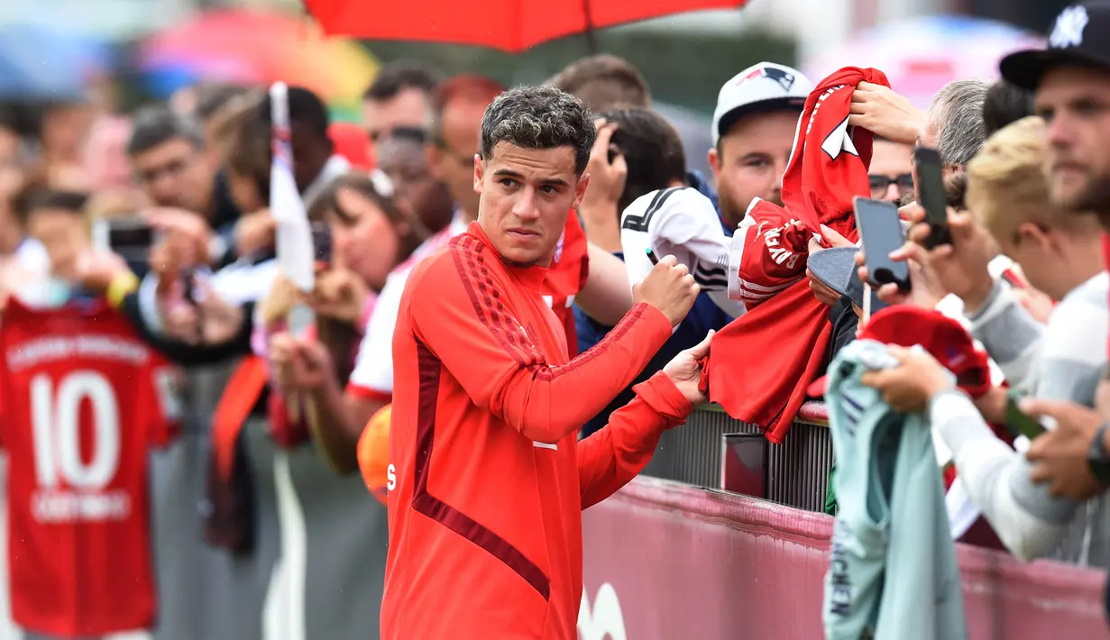 Pemain Bayern Munchen, Philippe Coutinho, menyapa suporter saat latihan perdananya di Munchen, Selasa (20/8). Bintang Brasil ini didatangkan dari Barcelona. (AFP/Christof Stache)