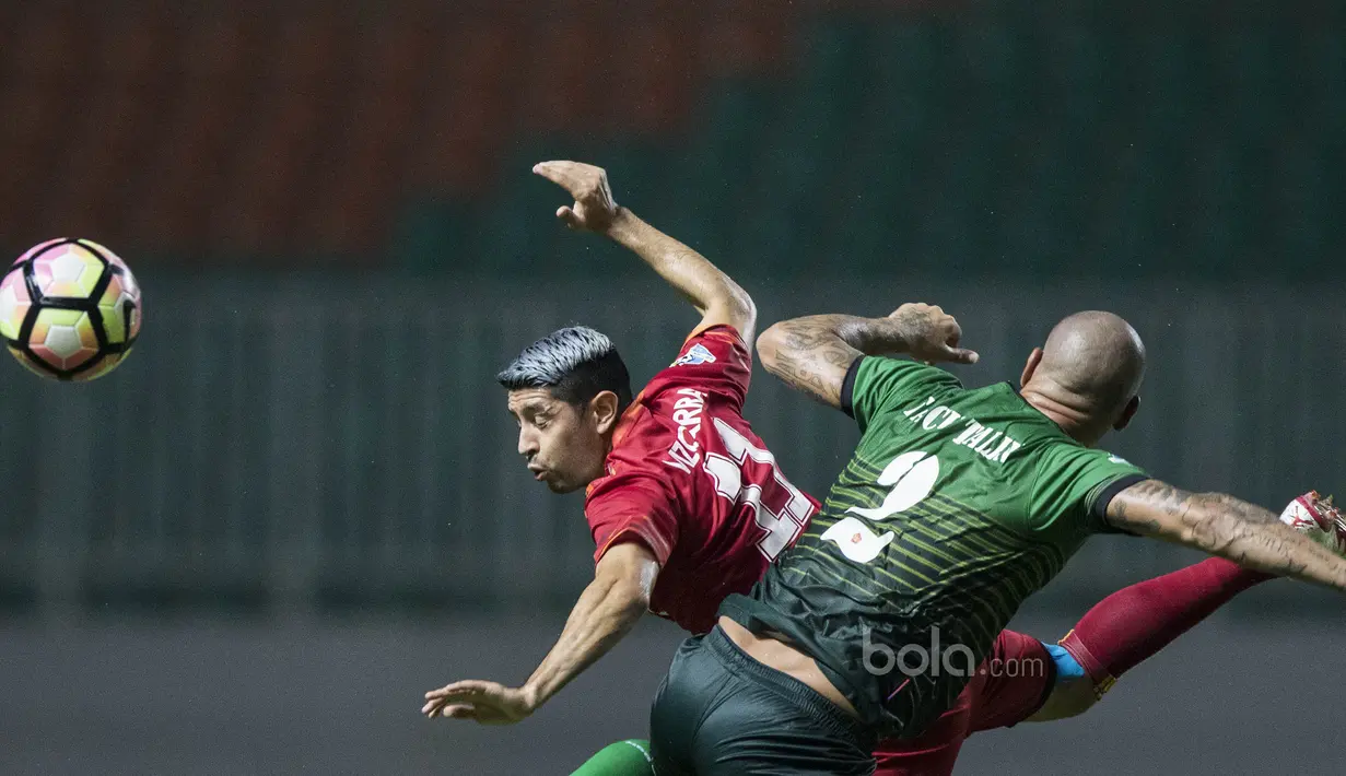 Gelandang Arema FC, Esteban Vizcarra, duel udara dengan bek PS TNI, Facundo Talin, pada laga Liga 1 di Stadion Pakansari, Bogor, Senin (3/7/2017). Kedua klub bermain imbang 0-0. (Bola.com/Vitalis Yogi Trisna)