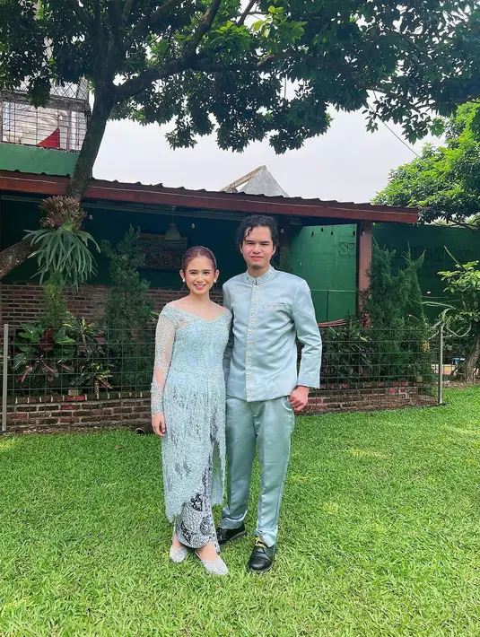 Kebaya model off shoulder tersebut tersebut dipadukan dengan kain batik dan sepatu brokat warna biru senada.