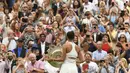 Penonton mengabadikan kemenangan petenis Spanyol, Garbine Muguruza, meraih juara Wimbledon usai menaklukkan Venus Williams di All England Lawn Tennis Club, Inggris, Sabtu (15/7/2017). Muguruza menang 7-5 dan 6-0 atas Williams. (AFP/Adrian Dennis)