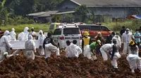 Pekerja menguburkan jenazah korban virus corona COVID-19 di TPU Pedurenan, Bekasi, Jawa Barat, Selasa (7/7/2021). Indonesia memperluas pembatasan untuk memerangi gelombang virus corona COVID-19 yang mematikan. (REZAS/AFP)