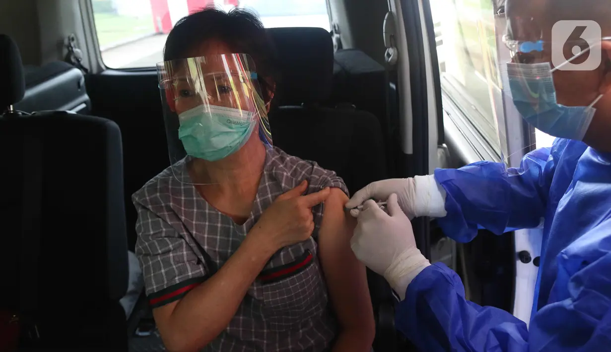 Warga mendapatkan suntikan vaksin COVID-19 di pos pelayanan vaksinasi Covid-19 Drive Thru Halodoc Kedua di West One City, Cengkareng, Jakarta, Rabu (10/3/2021). Pos Layanan Vaksinasi Drive Thru kedua itu diharapkan dapat mempermudah masyarakat mengakses vaksin Covid-19. (Liputan6.com/Angga Yuniar)