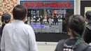 Orang-orang menonton berita TV yang melaporkan mantan Perdana Menteri Jepang Shinzo Abe ditembak, di Tokyo, Jumat (8/7/2022). Shinzo Abe yang berusia 67 tahun pingsan dan mengalami pendarahan di leher, kata seorang sumber dari Partai Demokrat Liberal yang berkuasa kepada kantor berita Jiji. (Kyodo News via AP)
