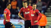 Reaksi Wayne Rooney dkk usai Manchester United tertinggal dari Wigan Athletic 0-1 pada partai lanjutan Liga Premier di DW Stadium, 11 April 2012. AFP PHOTO/ANDREW YATES