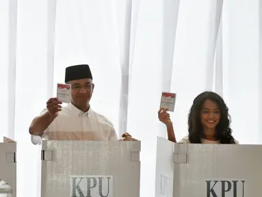 Cagub DKI Jakarta, Anies Baswedan bersama istri dan anaknya menunjukan kertas suara saat akan menggunakan hak pilihnya di TPS 28 Cilandak, Jakarta Selatan, Rabu (19/4). (Liputan6.com/Yoppy Renato)