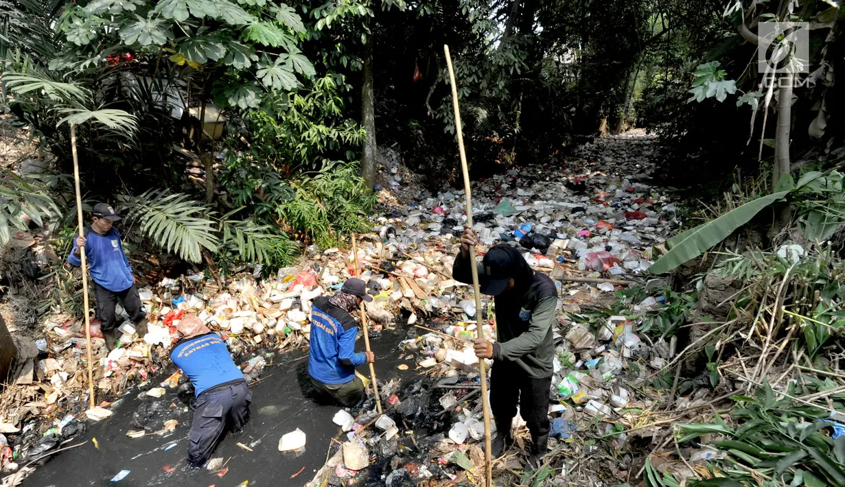 Petugas Satgas Sumber Daya Air Dinas PUPR Kota Depok melakukan pembersihan sampah sepanjang sekitar 500 meter yang memenuhi Kali Pelayangan di Kampung Utan Jaya, depok, Jawa Barat, Senin (12/8/2019). (merdeka.com/Arie Basuki)