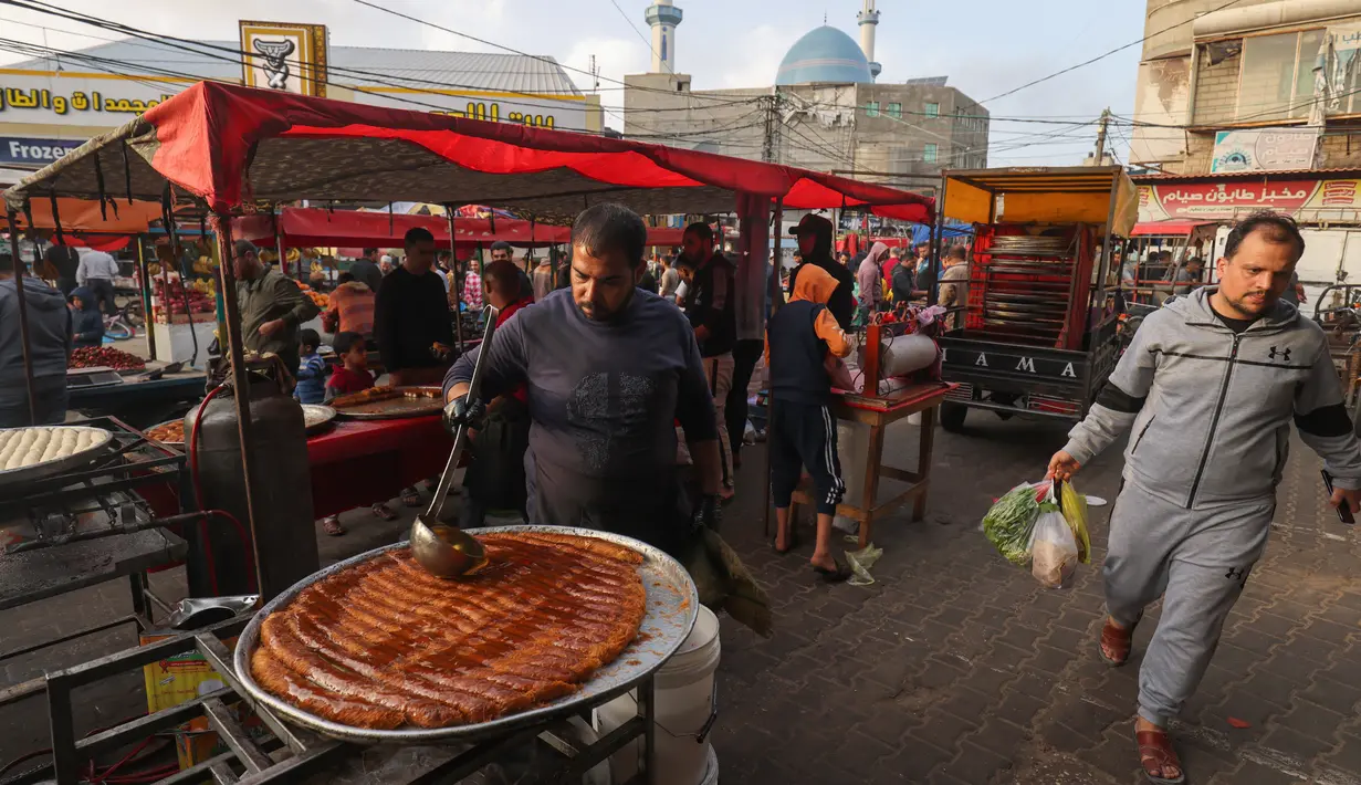 Warga Palestina berbelanja di pasar menjelang buka puasa selama bulan suci Ramadhan di kota Rafah, Jalur Gaza selatan, pada 10 April 2022. (SAID KHATIB / AFP)