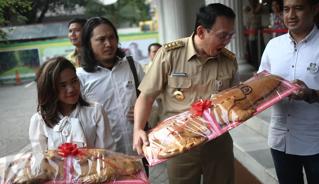 Gubernur DKI Basuki Tjahaja Purnama atau Ahok ketika menerima roti buaya dari relawan Ahok-Djarot di Balai Kota Jakarta, Senin (29/8). Roti buaya itu simbol warga meminang Ahok-Djarot pada Pilkada DKI Jakarta 2017. (Liputan6.com/Faizal Fanani)