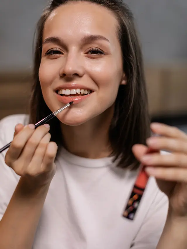 Pretty Woman Applying Lipstick