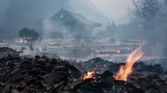 Bara api masih terlihat di antara puing-puing setelah sebagian besar bangunan hangus terbakar dalam kebakaran hutan di Kuil Gounsa, Uiseong, Korea Selatan pada 26 Maret 2025. (YASUYOSHI CHIBA/AFP)