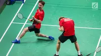 Pasangan ganda putra Indonesia, Kevin Sanjaya/Marcus Gideon, melakukan selebrasi usai mengalahkan  wakil Chinese Taipei, Lee Jhe-Huei/Lee Yang, pada laga Asian Games di Istora, Jakarta, Senin (27/8/). (Bola.com/Vitalis Yogi Trisna)