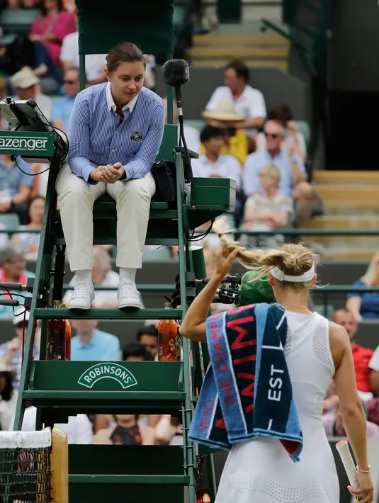 Petenis Denmark, Caroline Wozniacki mengeluhkan gangguan serangga terbang kepada wasit ketika melawan petenis Rusia, Ekaterina Makarova pada babak kedua Wimbledon 2018 di London, Rabu (4/7). Wozniacki tersingkir dengan skor 4-6, 6-1, 5-7. (AP/Ben Curtis)