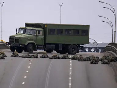 Tentara Ukraina mengambil posisi di sebuah jembatan di dalam Kota Kiev, Ukraina, Jumat (25/2/2022). Rusia menekan invasinya sampai ke pinggiran Kiev setelah melepaskan serangan udara di kota-kota dan pangkalan militer serta mengirimkan pasukan dan tank dari tiga sisi. (AP Photo/Emilio Morenatti)