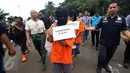 Polisi menggelar rekonstruksi kasus pencurian kabel di gorong-gorong di Jalan Medan Merdeka Selatan, Jakarta, Selasa (15/3). Empat dari enam tersangka dihadirkan untuk menunjukkan cara mereka memotong dan mencuri kabel. (Liputan6.com/Immanuel Antonius)