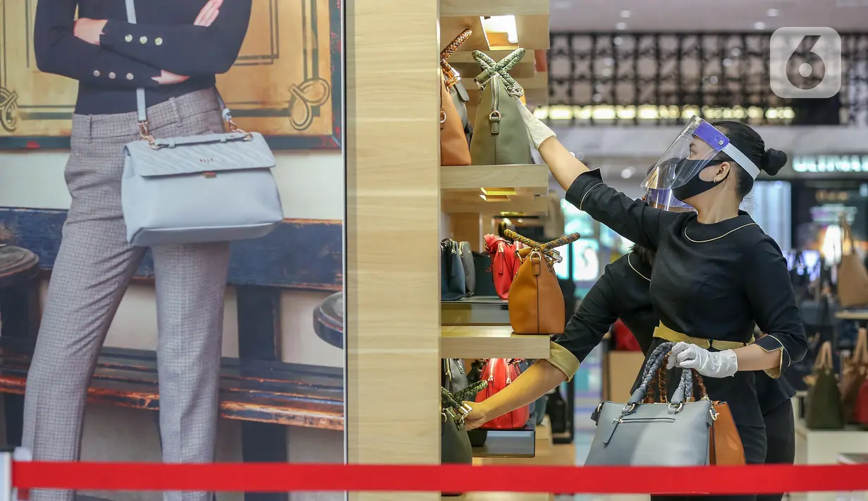 Pramuniaga merapikan tas di salah satu tenant di Lippo Mall Puri, Jakarta, Senin (15/6/2020). Pergub Nomor 51 tahun 2020 tentang PSBB pada masa transisi Lippo Malls di wilayah Jakarta kembali beroperasi pada pukul 12.00 – 20.00 WIB dengan menyiapkan protokol kesehatan. (Liputan6.com/Fery Pradolo)