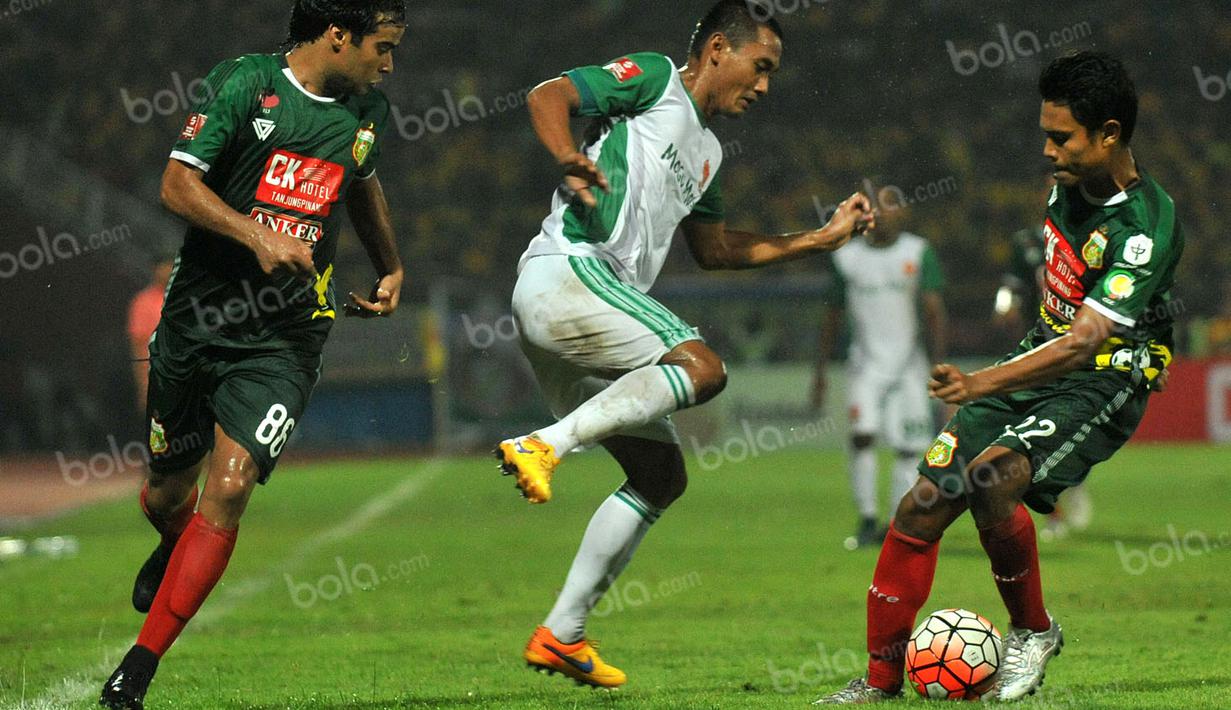 Pemain PS TNI, Legimin Raharjo (tengah), berusaha melewati hadangan pemain Bhayangkara Surabaya United dalam laga Torabika Soccer Championship 2016 presented by IM3 Ooredoo di Stadion Gelora Delta, Sidoarjo, Minggu (8/5/2016). (Bola.com/Fahrizal Arnas)