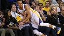 Stephen Curry #30 terjatuh menindih fans Golden State Warriors lsaat melawan Portland Trail Blazers  pada laga NBA Playoffs di ORACLE Arena,Oakland, California,(3/4/2016). (Ezra Shaw/Getty Images/AFP)