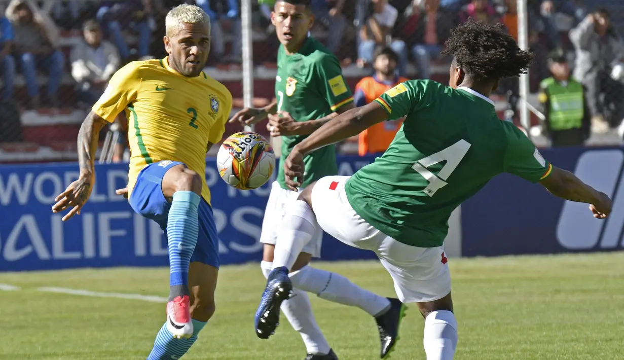 Aksi pemain Brasil, Dani Alves berebut bola dengan pemain Bolivia, Leonel Morales pada kualifikasi Piala Dunia 2018 zona CONMEBOL di La Paz, Bolivia, (5/10/2017). Brasil bermain imbang 0-0. (AFP/Auzar Raldes)