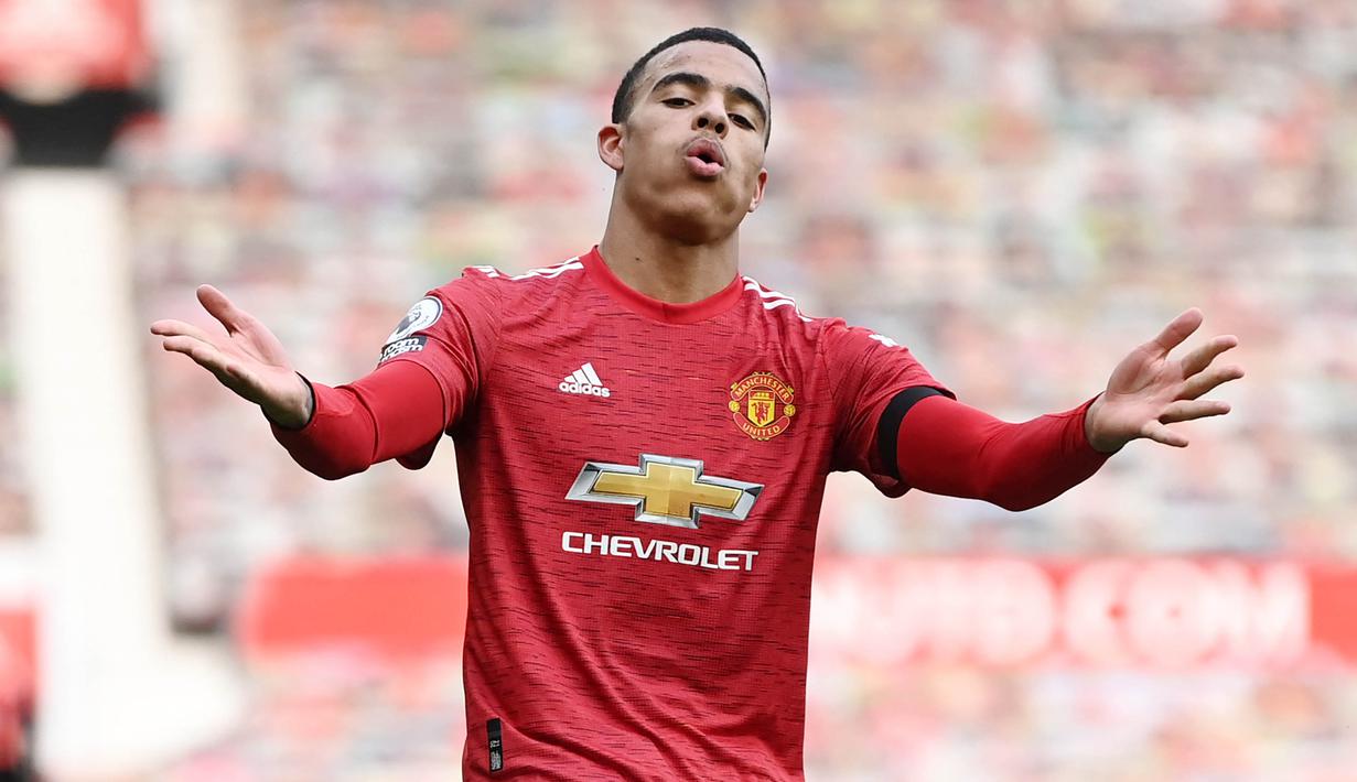 Striker Manchester United, Mason Greenwood, melakukan selebrasi usai mencetak gol ke gawang Burnley pada laga Liga Inggris di Stadion Old Trafford, Minggu (18/4/2021). MU menang 3-1 Burnley. (Photo by GARETH COPLEY/POOL/AFP)