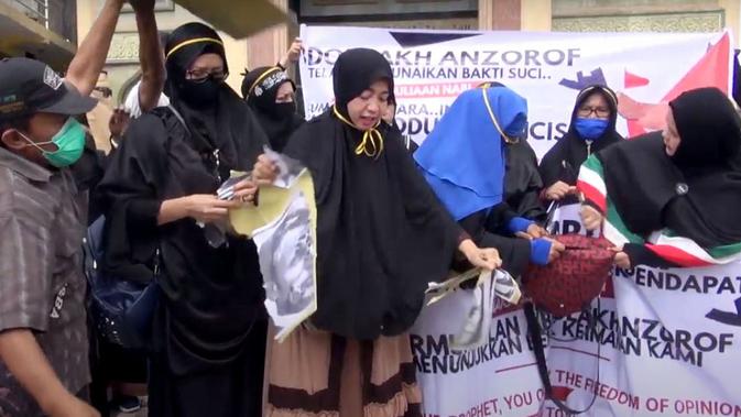 Para pengunjuk rasa juga tampak membawa 2 tas buatan Prancis, lalu mereka rusak dengan pisau sebagi sebagai simbol ajakan pemboikotan.