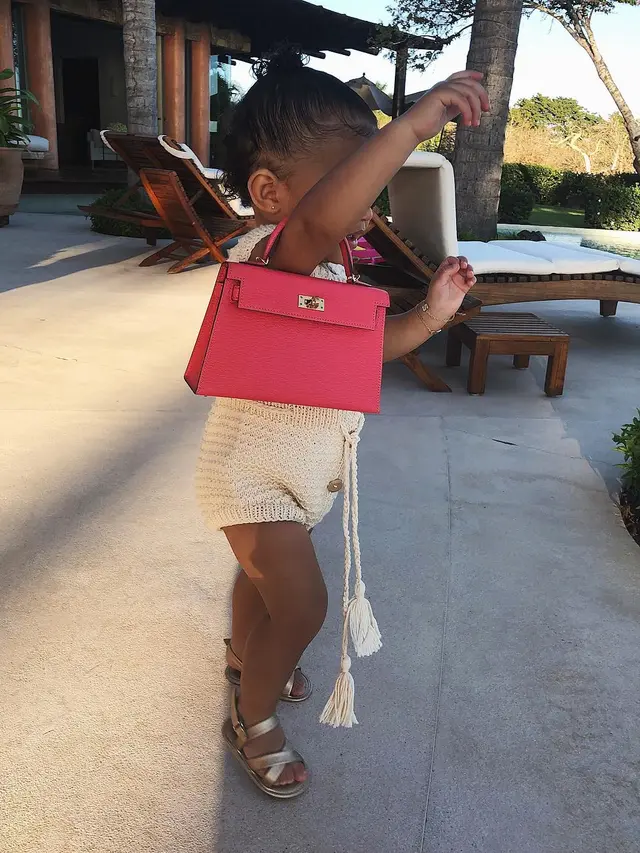 Tas Pertama Stormi Webster, merupakan karya rumah mode asal Perancis, Hermes dengan tipe mini Kelly.
