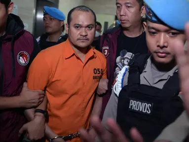Petugas Badan Reserse dan Kriminal (Bareskrim) Mabes Polri mengawal ketat Chaowalit Thongduang (tengah) saat akan dibawa menuju Bandara Soekarno-Hatta untuk diekstradisi ke negara asalnya, Jakarta pada tanggal 4 Juni 2024. (Bay ISMOYO/AFP)
