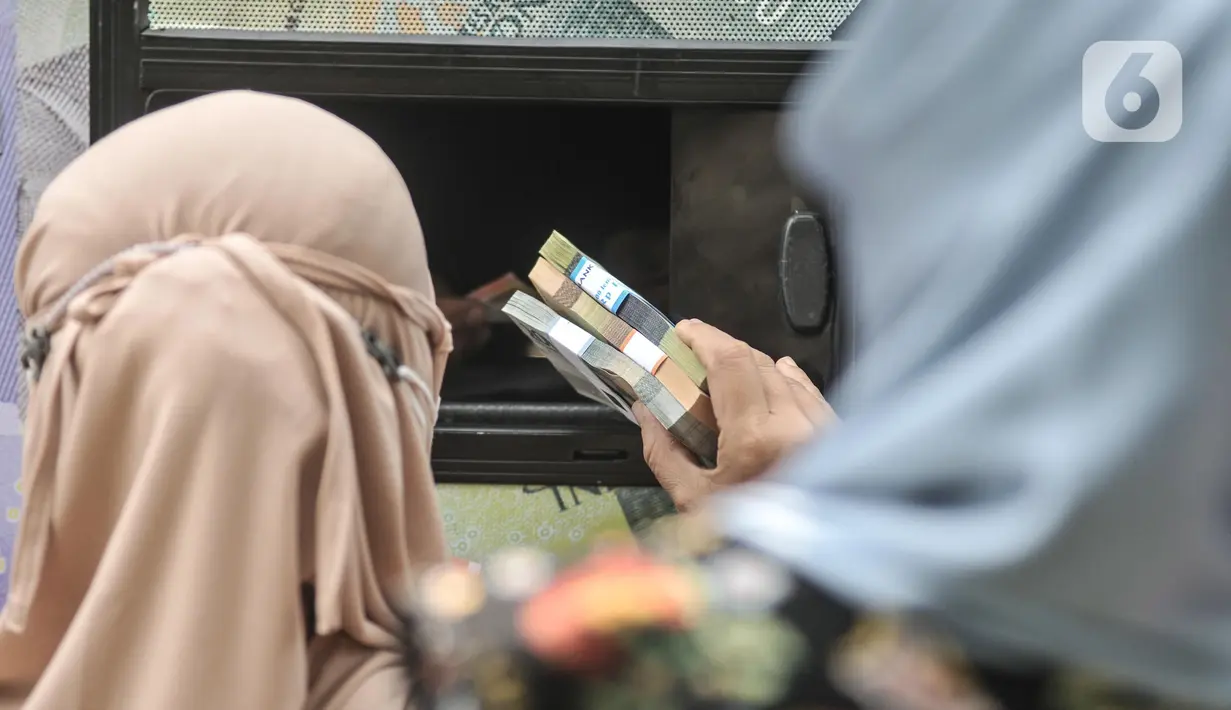 Warga menukarkan uang pecahan kecil di mobil Kas Keliling BI, Pasar Rawa Bening, Jatinegara, Jakarta Timur, Senin (18/4/2022). Bank Indonesia (BI) telah menyiapkan layanan penukaran uang tunai baru untuk kebutuhan Ramadhan dan Idul Fitri. (merdeka.com/Iqbal S.Nugroho)