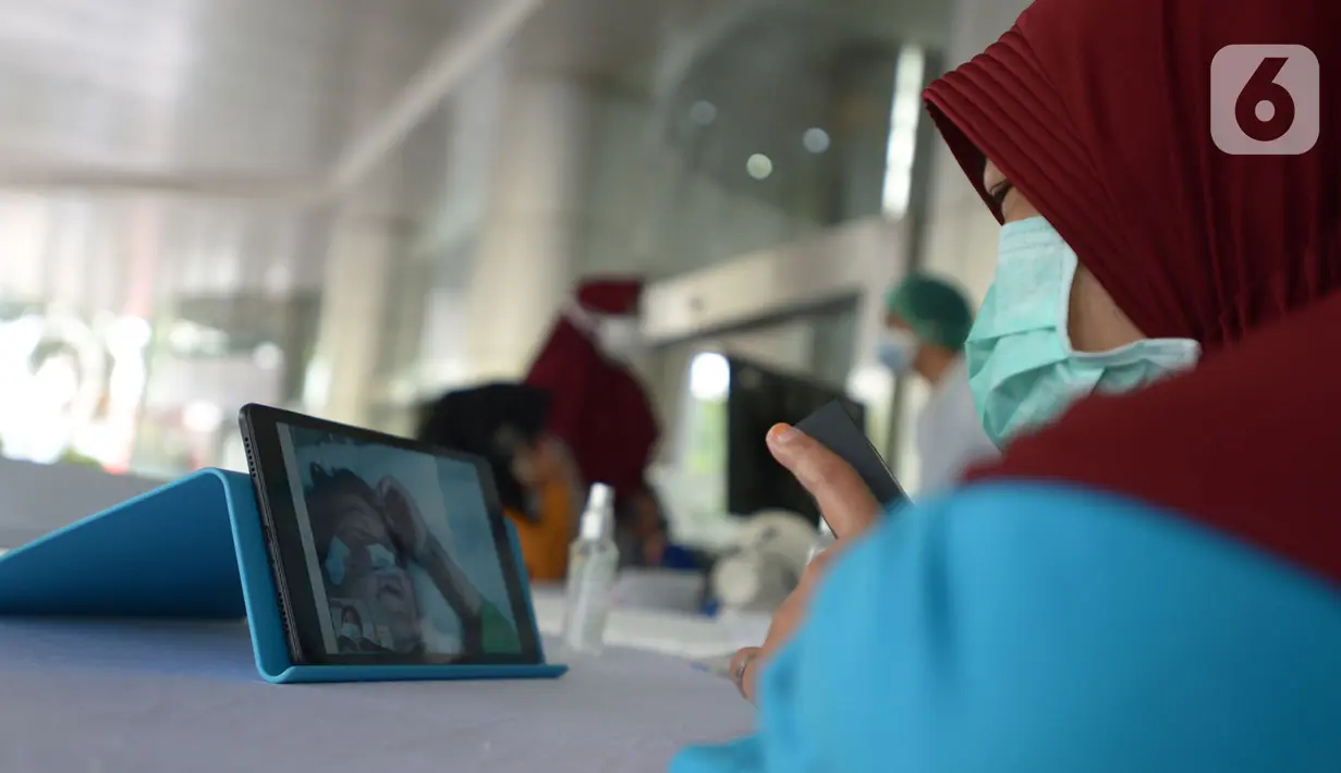 Keluarga melakukan video call dengan pasien di RSCM, Jakarta, Selasa (26/5/2020). Fasilitas itu bernama "Pojok Sahabat",Karena tidak bisa jenguk langsung untuk bertegur sapa dengan keluarga yang dirawat dalam ruangan khusus memalui video call. (merdeka.com/Imam Buhori)