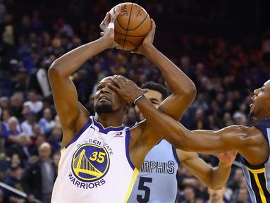 Pemain Warriors, Kevin Durant #35 mencoba memasukan bola saat diadang pemain Memphis Grizzlies, Mario Chalmers #6 pada laga NBA basketball games di ORACLE Arena, Oakland (20/12/2017). Warriors menang 97-84. (Ezra Shaw/Getty Images/AFP)