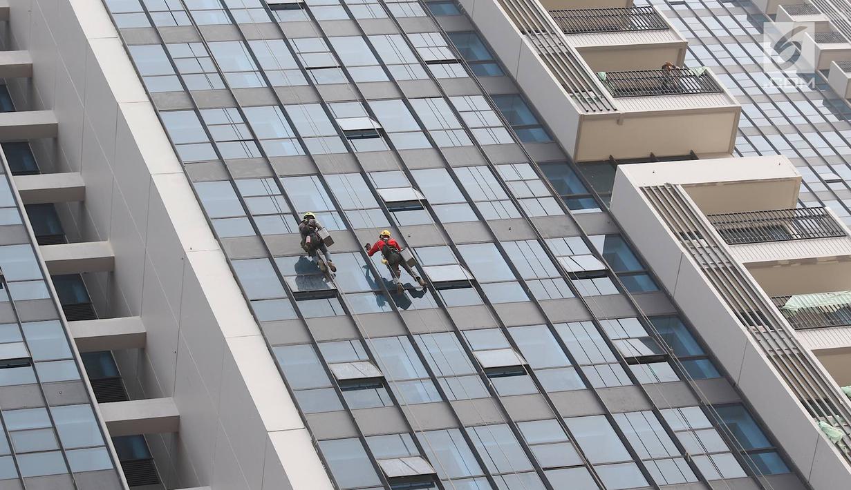Pekerja membersihkan kaca gedung di Jakarta, Kamis (18/10). Kepesertaan BPJS Ketenagakerjaan tahun 2018 sebanyak 29,6 juta peserta aktif, atau tumbuh 12,9% dari jumlah peserta aktif tahun 2017 sebanyak 26,2 juta peserta. (Liputan6.com/Immanuel Antonius)