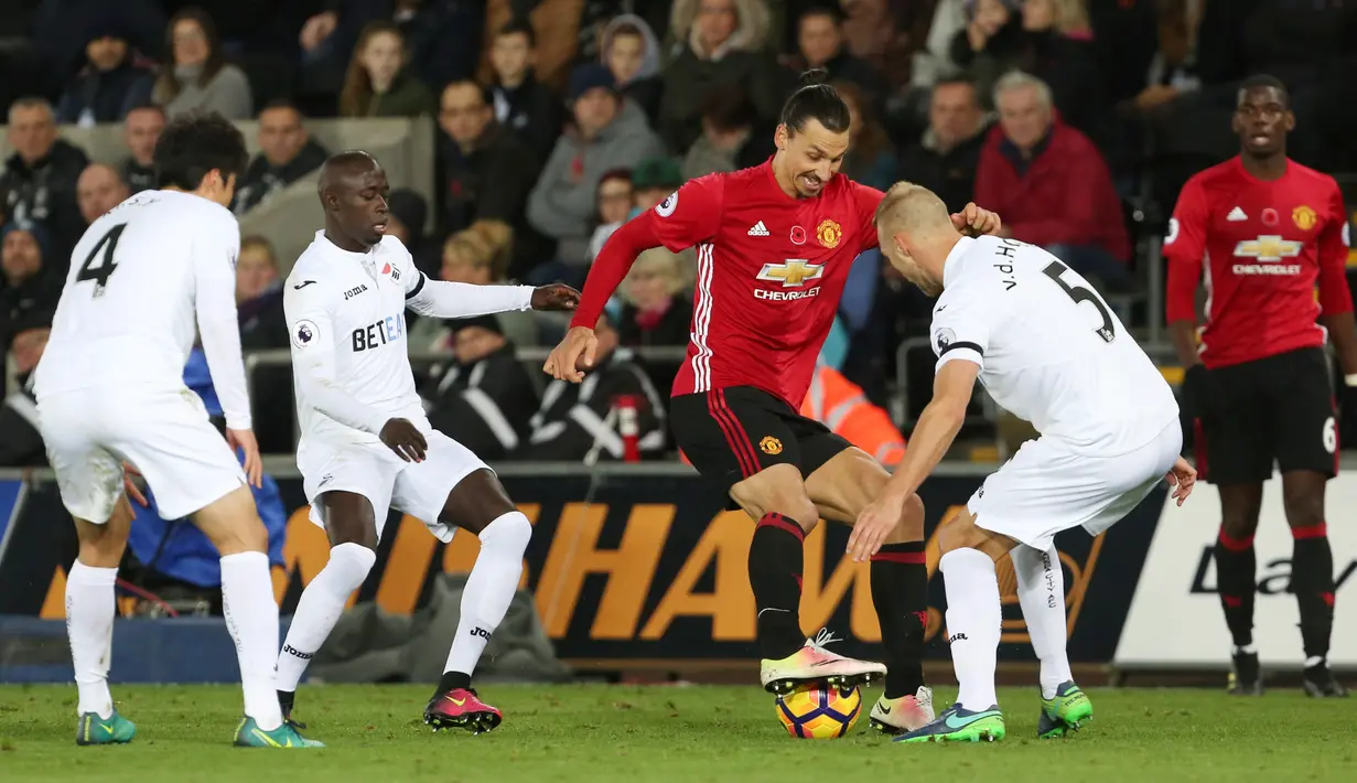Penyerang Manchester United, Zlatan Ibrahimovic mencoba melewati pemain belakang Swansea City, Mike van der Hoorn saat pertandingan Liga Premier Inggris, Swansea City menjamu Manchester United di Stadion Liberty, Inggris (6/11). (AFP/Geoff Caddick)