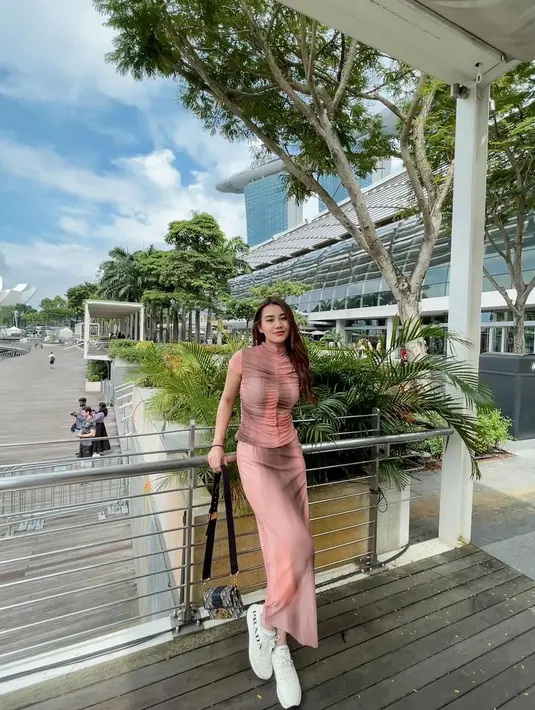 Tampil trendy dengan one set crop top dan pencil skirt motif tie dye yang stylish. Untuk alas kaki, Aaliyah memilih sneakers putih yang nyaman. [@aaliyah.massaid].