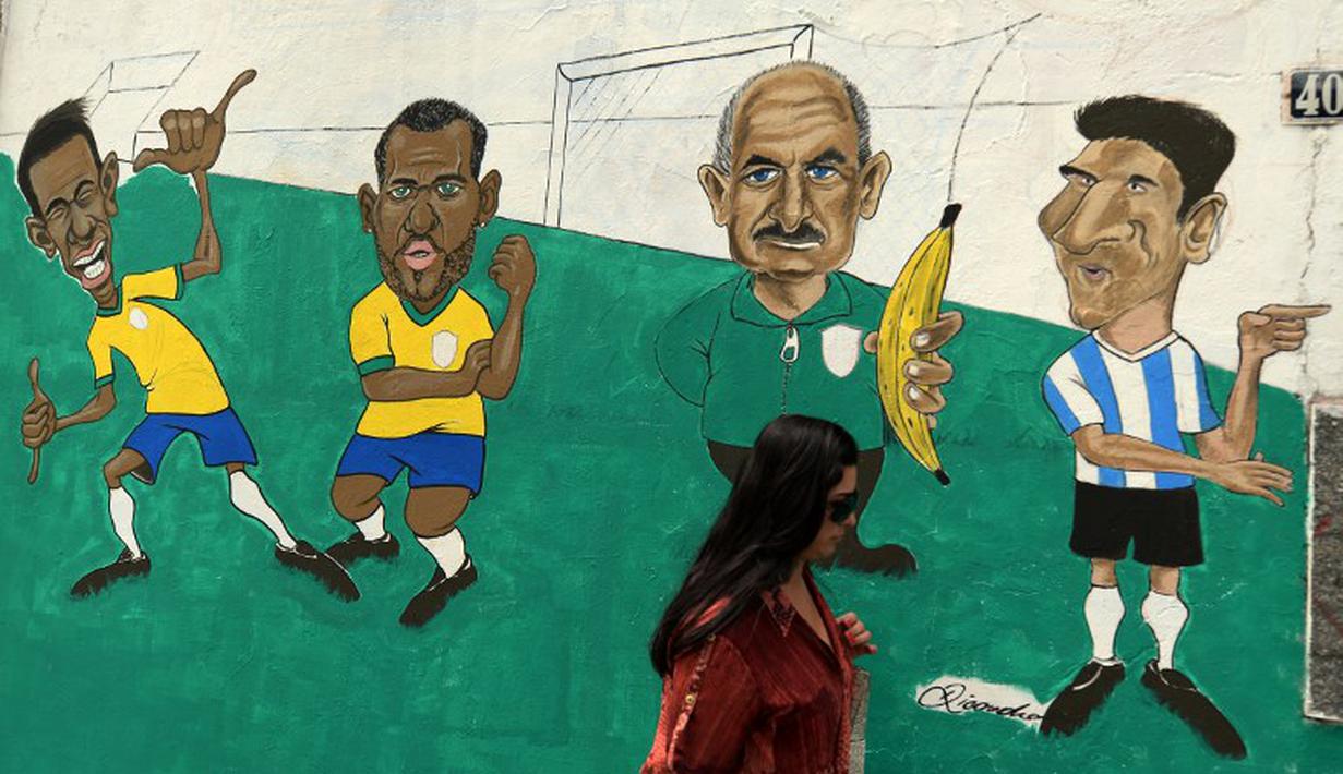Sebagai rival utama Brasil, Lionel Messi digambarkan sebagai sosok utama lawan yang harus diwaspadai. Mural ini terdapat di Rio de Janeiro, Brasil. (AFP Photo/Vanderlei Almeida)
