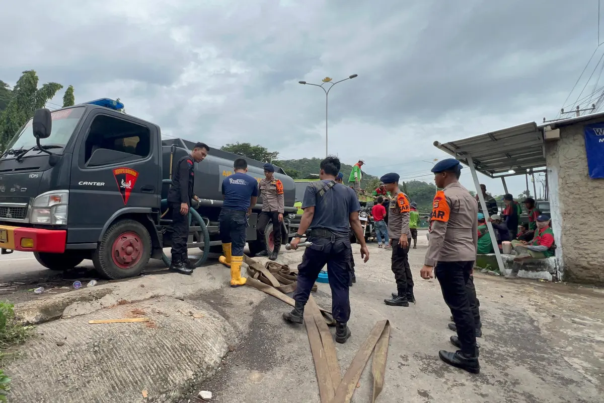 Personel Satbrimob Polda Lampung menyalurkan 5000 liter air bersih untuk warga yang terdampak banjir di Bandar Lampung. Foto : (Istimewa).