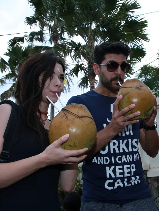 Aura cinta di antara Emre Kivilcim dan Gulcin Tuncok semakin terlihat saat menikmati segarnya kelapa hijau di Bali. (Deki Prayoga/Bintang.com)