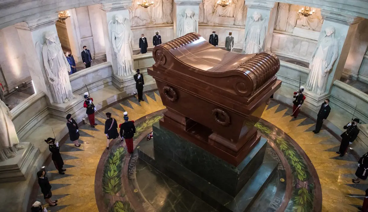 Presiden Prancis Emmanuel Macron dan istrinya Brigitte Macron berdiri di depan makam Kaisar Prancis Napoleon (1769-1821) saat upacara peringatan 200 tahun kematiannya di Chapelle Saint-Jerome, Invalides, Paris, Prancis, Rabu (5/5/2021). (Christophe PETIT TESSON/POOL/AFP)