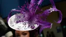 Seorang wanita mengenakan hiasan kepala saat ia tiba untuk hari pertama pertemuan pacuan kuda Royal Ascot di Ascot, Inggris (20/6). Mereka tampil gaya saat menyaksikan kompetisi balap kuda ini. (AP Photo/Alastair Grant)