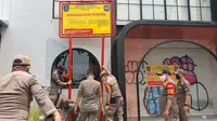 Satpol PP Kota Depok melakukan penyegelan minimarket di Jalan Raya Margonda. (Liputan6.com/Dicky Agung Prihanto)