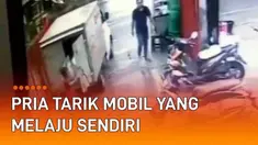 CCTV merekam momen heroik seorang pria di belakang mobil boks. Ketika pria itu hendak mengangkut barang, mobil boks tiba-tiba bergerak sendiri. Pria berbaju merah itu langsung berusaha menahan laju mobil di jalan menurun.