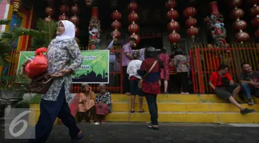 Seorang warga membawa sembako yang di bagikan oleh warga keturunan Tionghoa di Klenteng Fuk Ling Miau, Yogyakarta, Jumat (1/7). Pembagian sembako dilakukan sebagai bentuk kepedulian terhadap sesama di bulan ramadan. (Liputan6.com/Boy Harjanto)