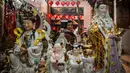 Para sukarelawan membersihkan patung-patung dewa di Kuil Hong San Ko Tee, Surabaya, Jawa Timur, pada Rabu 11 Februari 2026. (JUNI KRISWANTO/AFP)