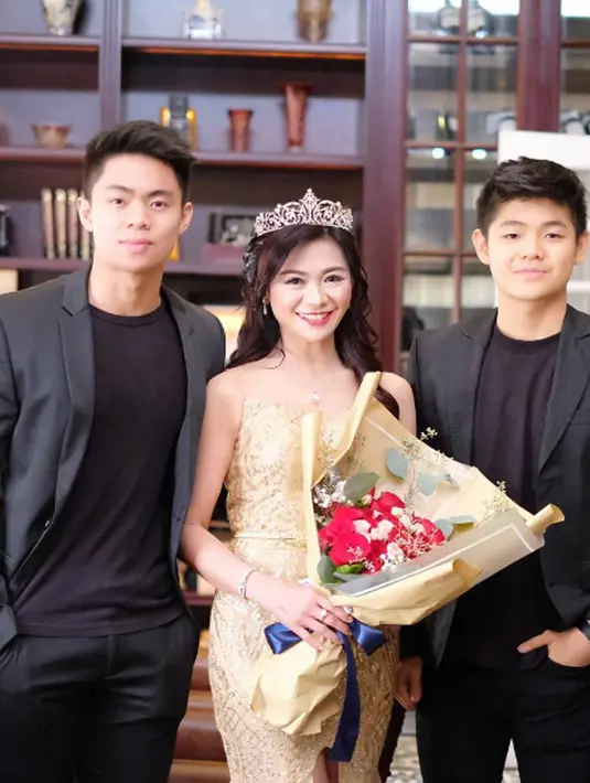 Tante Puspa Dewi memakai mahkota berpose dengan kedua anaknya Dennis Hadi dan Alex Daniel Hadi. (Instagram/@puspadewihc)