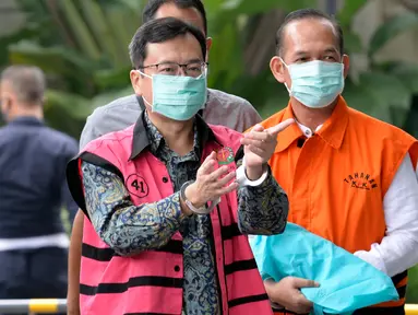 Komisaris PT Hanson International Tbk (MYRX), Benny Tjokrosaputro (kiri) dan Plt Kepala Dinas PUPR Muara Enim, Ramlan Suryadi (kanan) berjalan masuk akan menjalani pemeriksaan oleh penyidik di Gedung KPK, Jakarta, Selasa (9/6/2020). (merdeka.com/Dwi Narwoko)