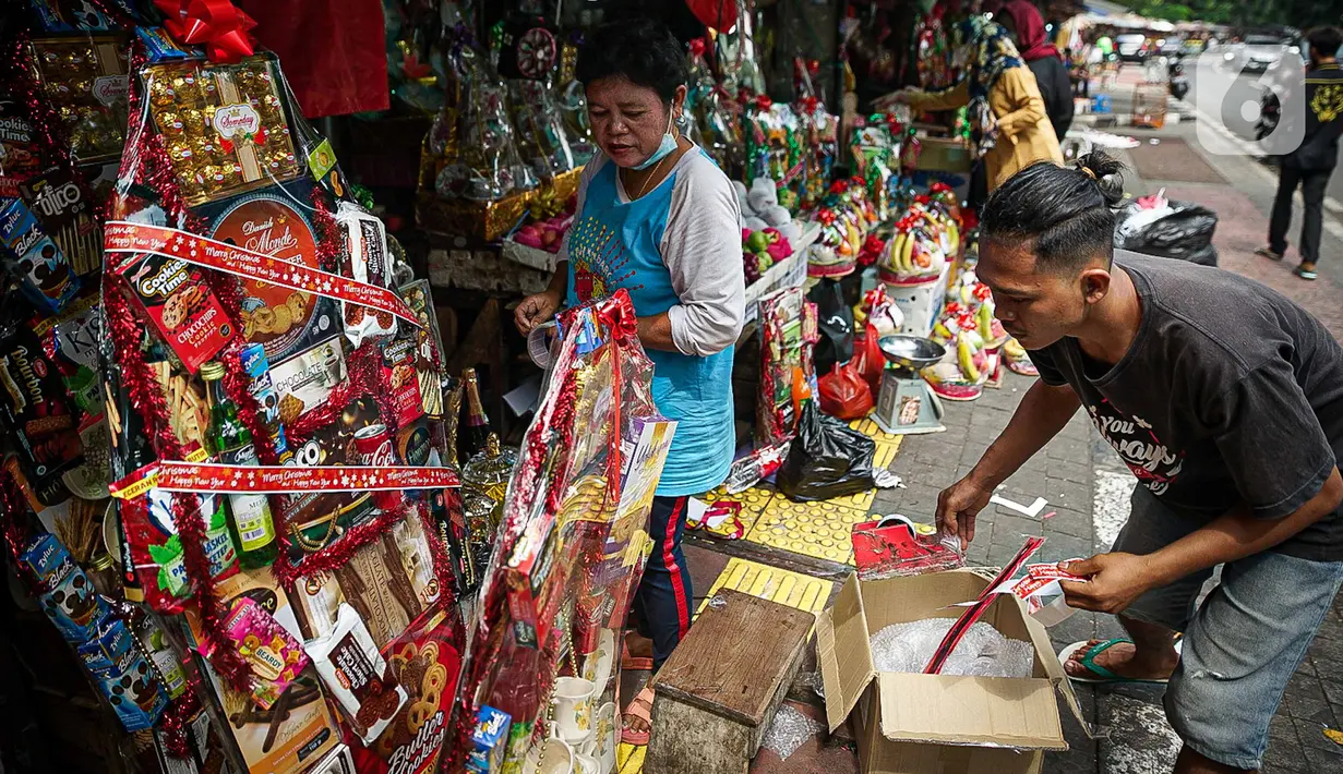 Pedagang membuat parsel Natal di Pasar Barito, Jakarta, Kamis (23/12/2021). Pedagang mengakui penjualan parsel sebagai hantaran Natal mulai ramai. Parsel yang paling banyak diminati adalah parsel makanan dengan harga mulai dari Rp 100.000 hingga Rp 800.000. (Liputan6.com/Faizal Fanani)