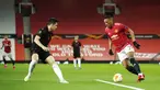 Pemain Manchester United Anthony Martial (kanan) menggiring bola menghadapi pemain Real Sociedad Igor Zubeldia pada pertandingan leg kedua babak 32 besar Liga Europa di Old Trafford, Manchester, Inggris, Kamis (25/2/2021). Laga berakhir 0-0 dan MU lolos ke babak 16 besar. (AP Photo/Dave Thompson)