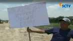 Warga juga membawa poster kertas bertuliskan ungkapan protes atas ditutupnya akses jalan kampung mereka yang membentang utara ke selatan