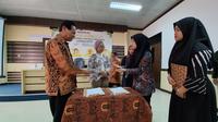 Sekretaris Jenderal AJI Indonesia Ika Ningtyas (kedua kiri) usai menandatangi kerjasama antara AJI Indonesia, AJI Jambi, dan Prodi Bahasa dan Sastra Indonesia (PBSI) FKIP UNJA, Rabu (15/3/2023). (Liputan6.com/Gresi Plasmanto)