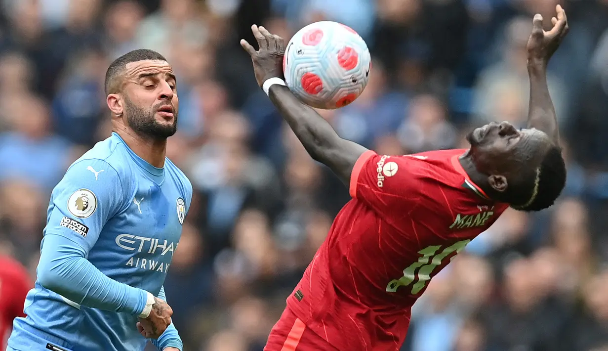 Striker Liverpool, Sadio Mane (kanan) mengontrol bola di depan bek Manchester City, Kyle Walker pada laga Liga Inggris 2021/2022 di Etihad Stadium, Manchester (10/4/2022). Sadio Mane menjuarai Liga Inggris bersama Liverpool pada musim 2019/2020. Sebelum diboyong The Reds pada awal musim 2016/2017 dari Southampton yang dibelanya pada 2014/2015 dan 2015/2016, Sadio Mane pernah membela RB Salzburg pada musim 2012/2013 dan 2013/2014. (AFP/Paul Ellis)